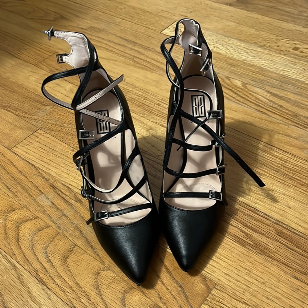 High heeled black leather pumps